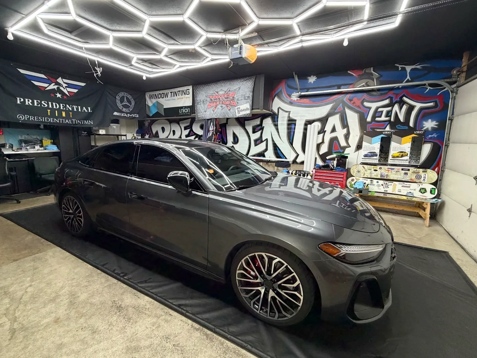 A freshly tinted gray sedan in the Presidential Tint MN shop in South Saint Paul