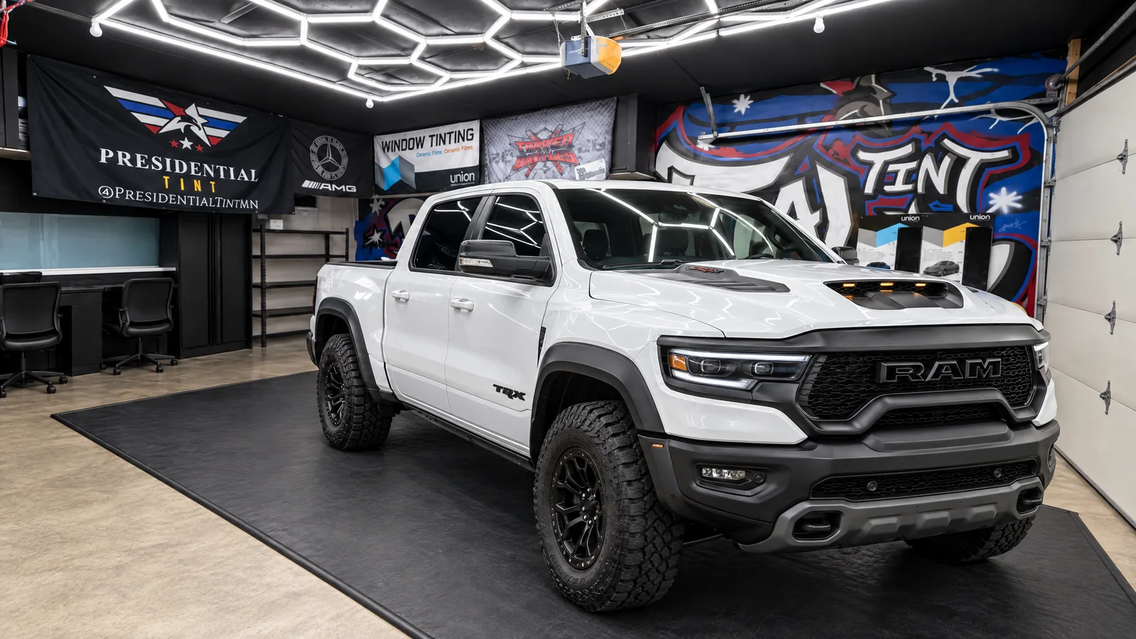 A white RAM 1500 TRX with freshly tinted windows in the Presidential Tint MN shop in South Saint Paul, MN